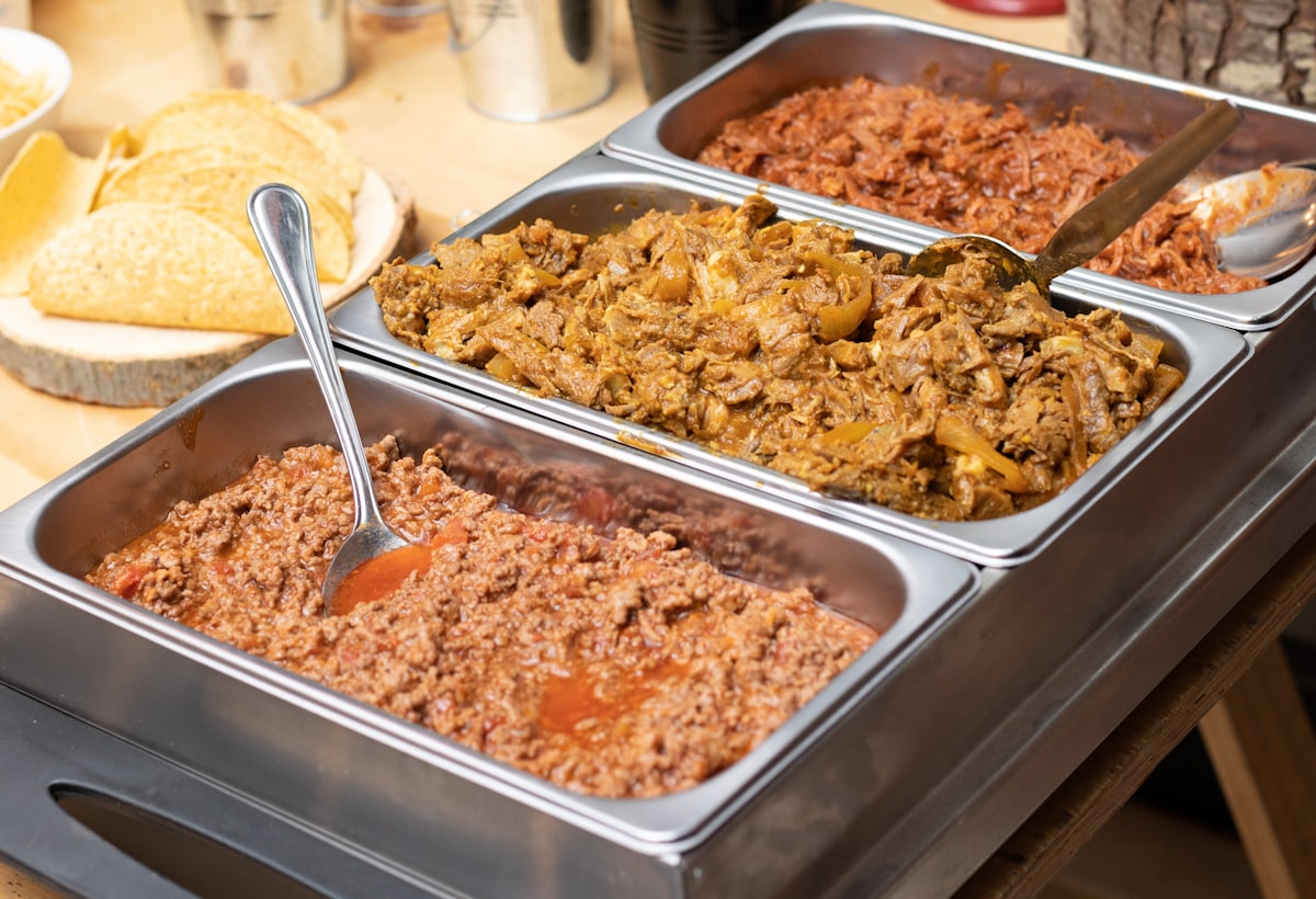 Large catering trays of biryani and rice dishes